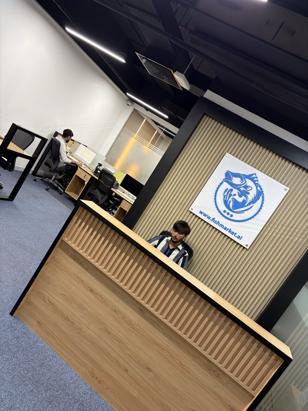 FishMarket.ai office reception and branded wall